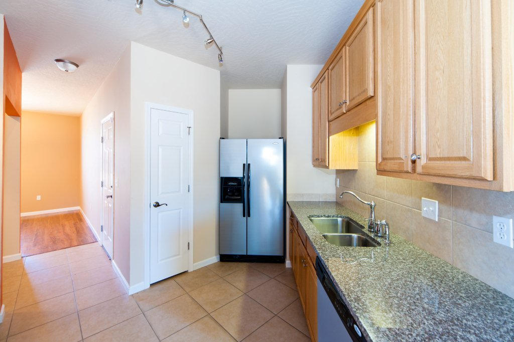 4625 Hermosa Road Crestview, FL 32539 - Photo 12 of 37 a kitchen with a sink a refrigerator and cabinets