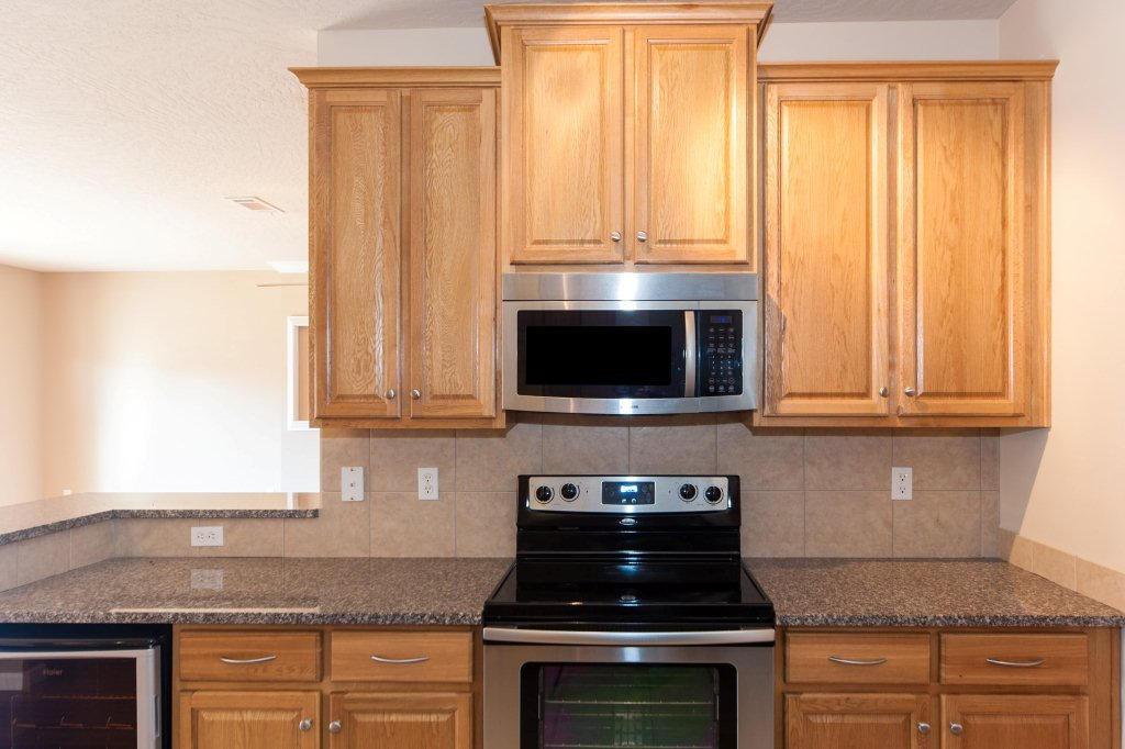 4625 Hermosa Road Crestview, FL 32539 - Photo 14 of 37 a kitchen with granite countertop a stove top oven cabinetry a sink and dishwasher