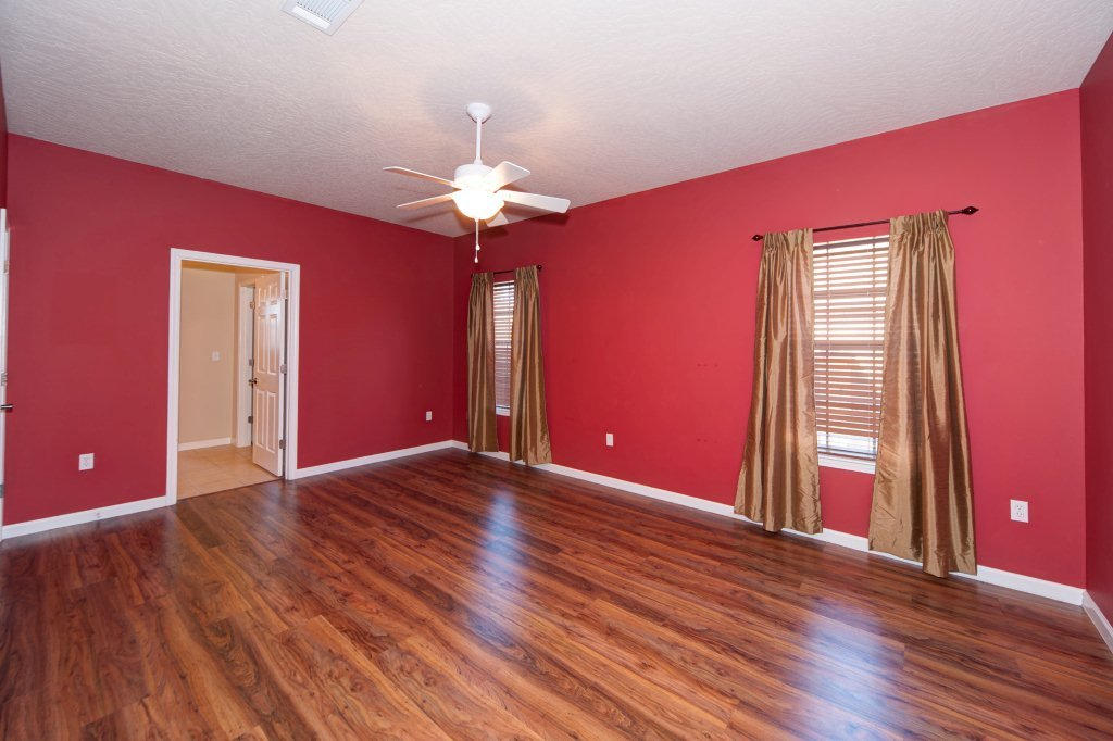 4625 Hermosa Road Crestview, FL 32539 - Photo 18 of 37 a view of an empty room with a window and wooden floor
