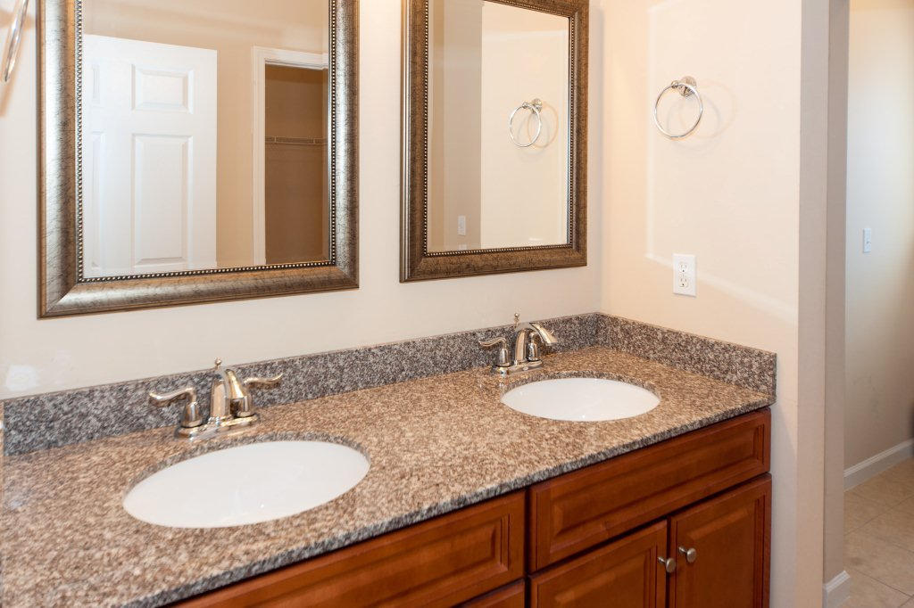 4625 Hermosa Road Crestview, FL 32539 - Photo 20 of 37 a bathroom with a granite countertop sink and a mirror