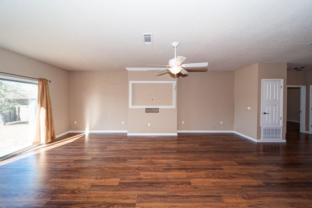 4625 Hermosa Road Crestview, FL 32539 - Photo 27 of 37 a view of an empty room with wooden floor and a window