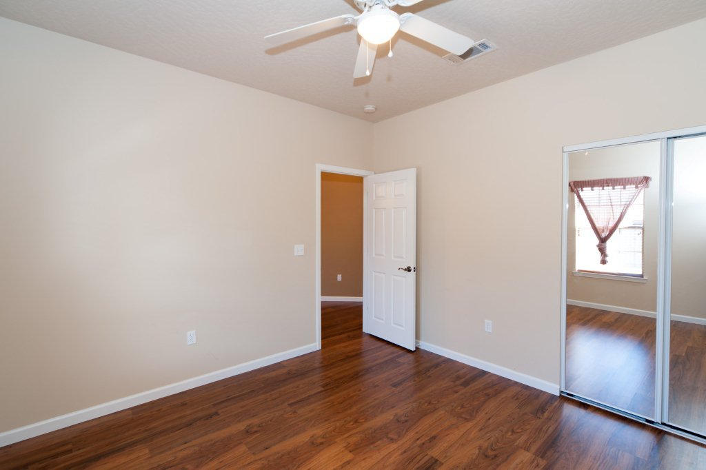 4625 Hermosa Road Crestview, FL 32539 - Photo 30 of 37 an empty room with wooden floor closet and windows