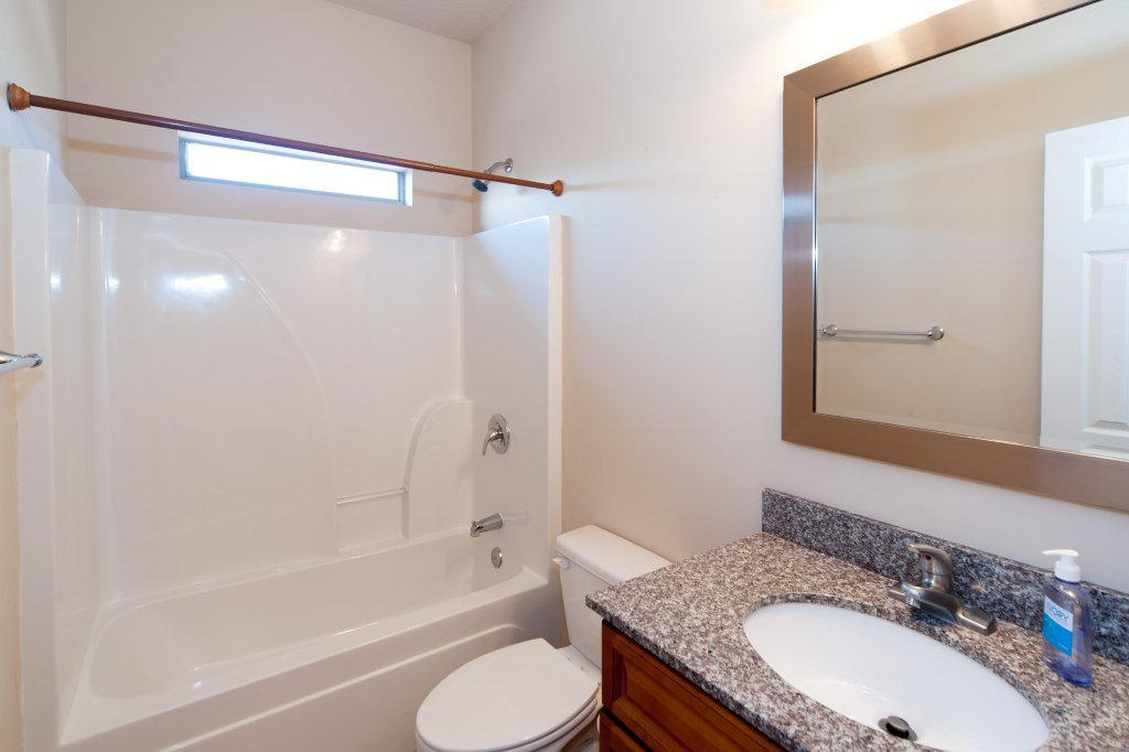 4625 Hermosa Road Crestview, FL 32539 - Photo 31 of 37 a bathroom with a granite countertop sink toilet and shower