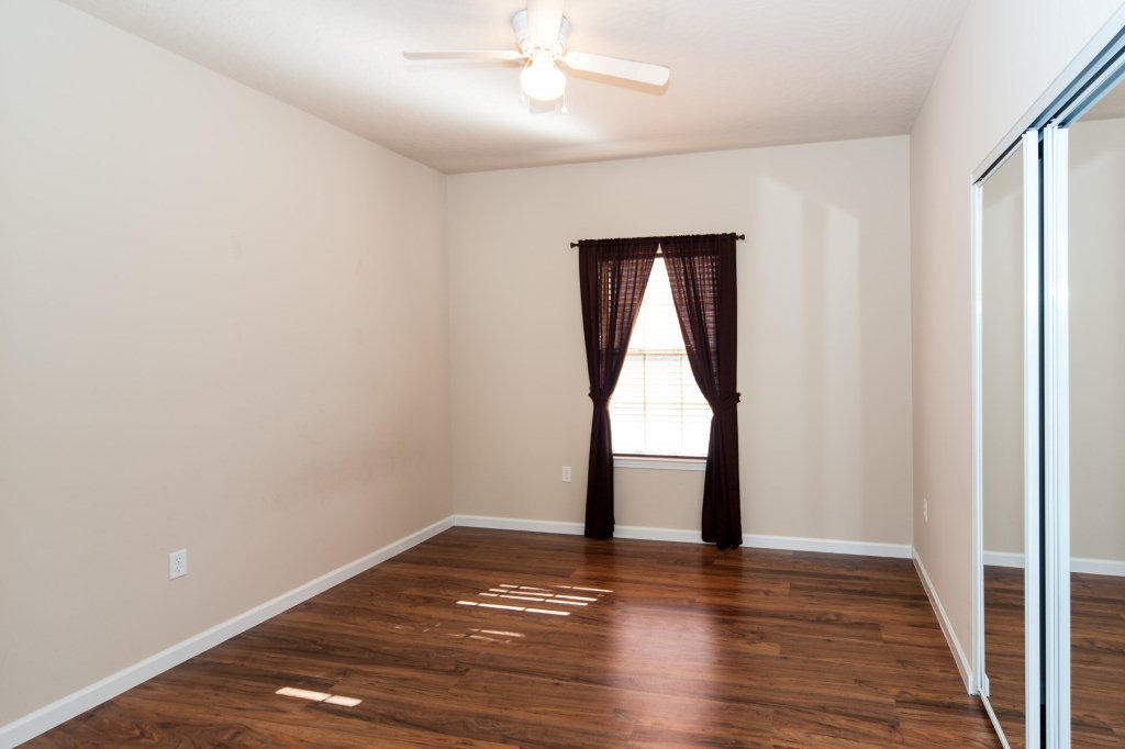 4625 Hermosa Road Crestview, FL 32539 - Photo 32 of 37 a view of empty room with wooden floor and fan