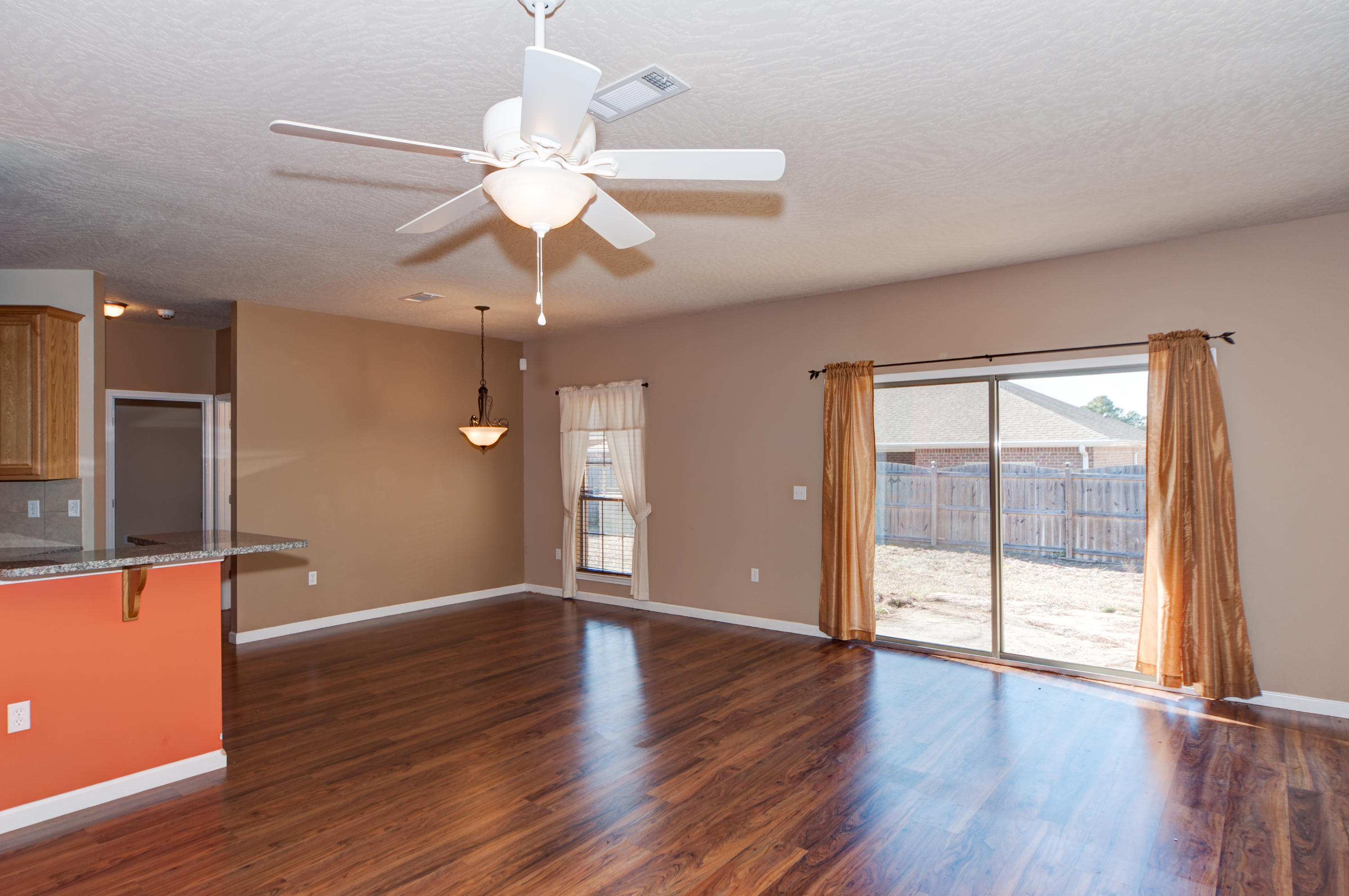 4625 Hermosa Road Crestview, FL 32539 - Photo 5 of 37 a view of an empty room with wooden floor and a window