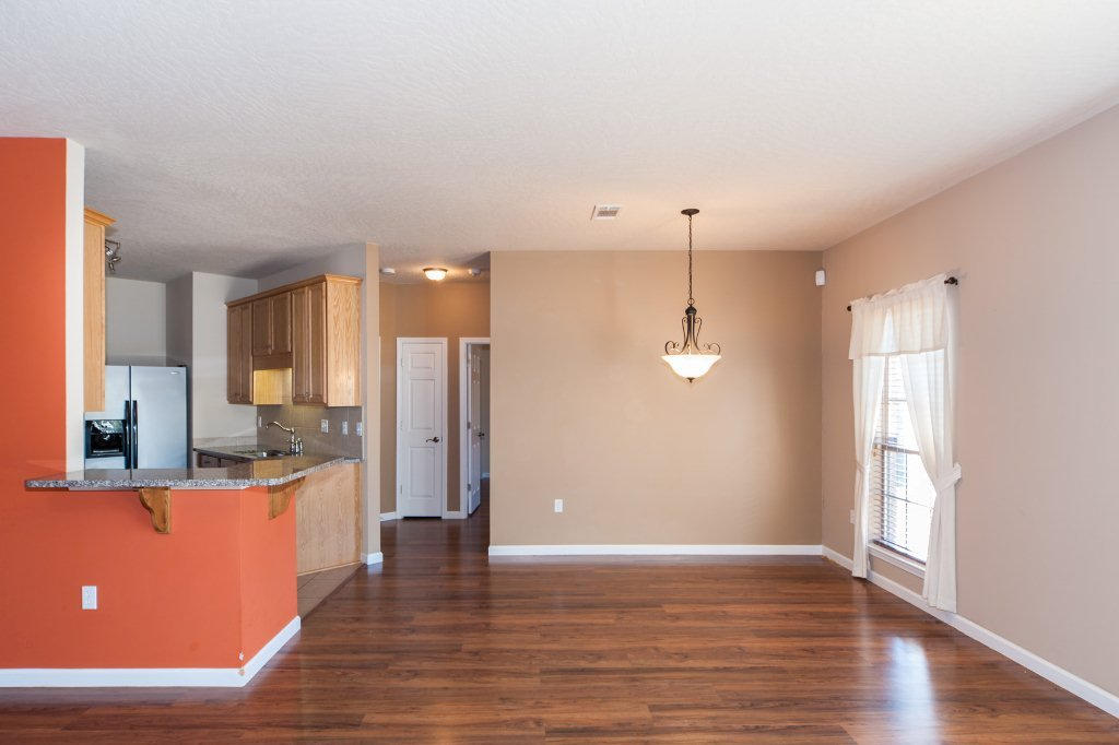 4625 Hermosa Road Crestview, FL 32539 - Photo 6 of 37 a view of a kitchen with a refrigerator cabinets and a wooden floor