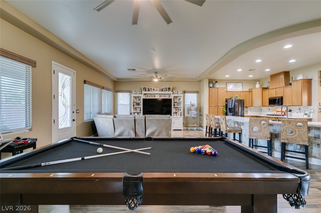 7524 Midnight Rambler Street Las Vegas, NV 89149 - Photo 13 of 51 An inviting open-concept area combines a lively game room with a casual kitchen for effortless entertaining.