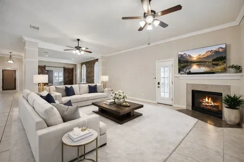 a living room with furniture a chandelier and a fireplace