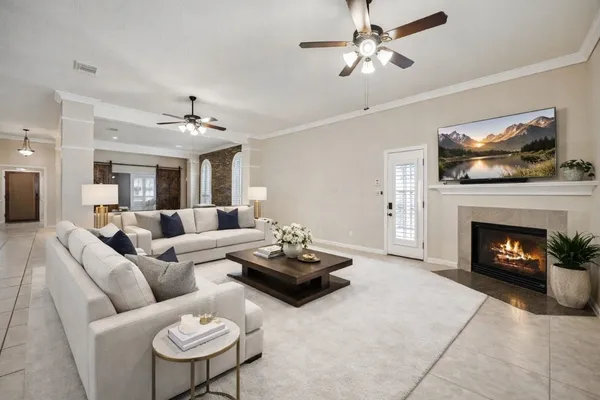 a living room with furniture a chandelier and a fireplace