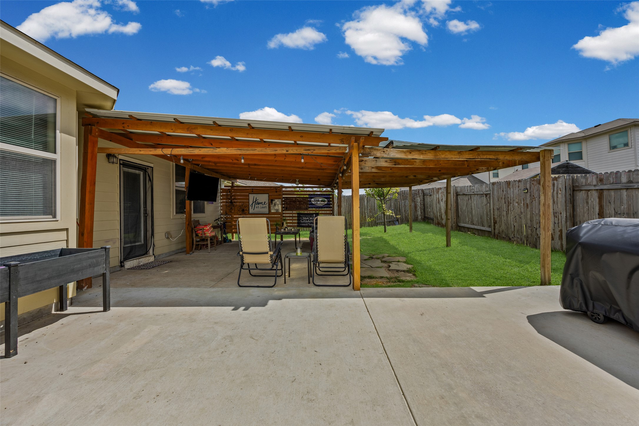 19113 Rookery Trail Pflugerville, TX 78660 - Photo 26 of 36 Spacious concrete patio with an attached wood-frame pergola