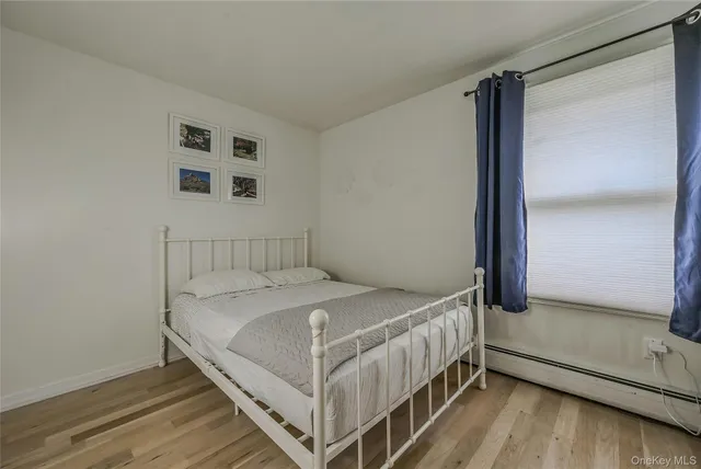 a bed sitting in a bedroom next to a window