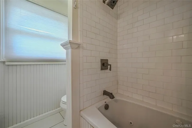 a bathroom with a bathtub and shower