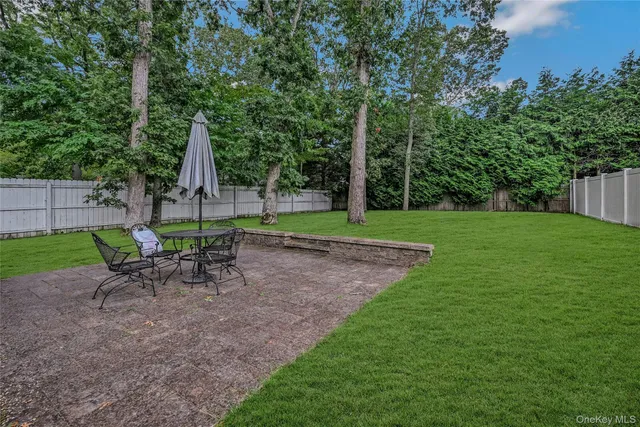 a view of a chair and table in the garden