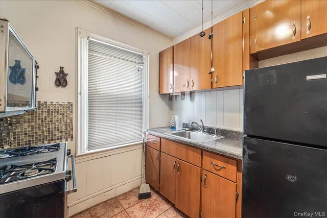 a kitchen with a sink stove and refrigerator