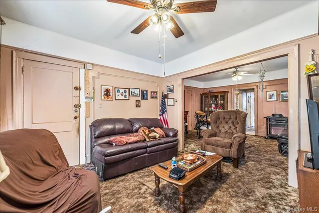 a living room with furniture a rug and a chandelier