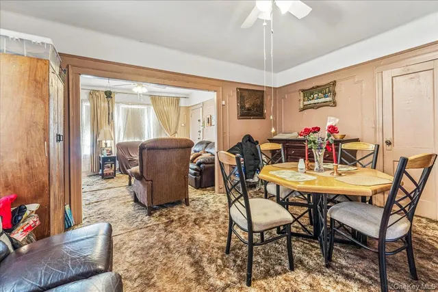 a dining room with furniture window and wooden floor