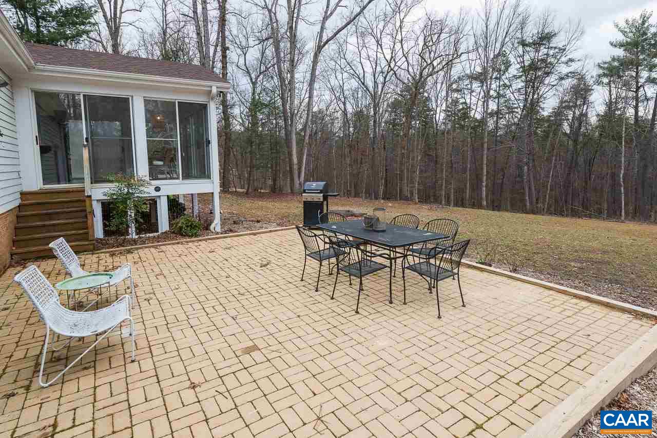 1314 Tilman Road Charlottesville, VA 22901 - Photo 11 of 27 Enjoy the peaceful natural surroundings, expansive level yard and woods, from the new patio. A generous 16' X 16', it can accommodate separate eating and sitting areas and is easily accessed from the sun room and the rec room.