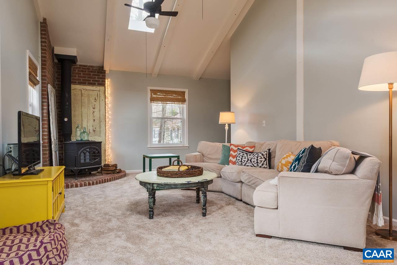 1314 Tilman Road Charlottesville, VA 22901 - Photo 4 of 27 Located just off the foyer, separate from the rest of the living area, the great room with its vaulted ceiling and skylights is spacious and welcoming. A wood burning stove with corner brick surround adds a warm, welcoming feel.