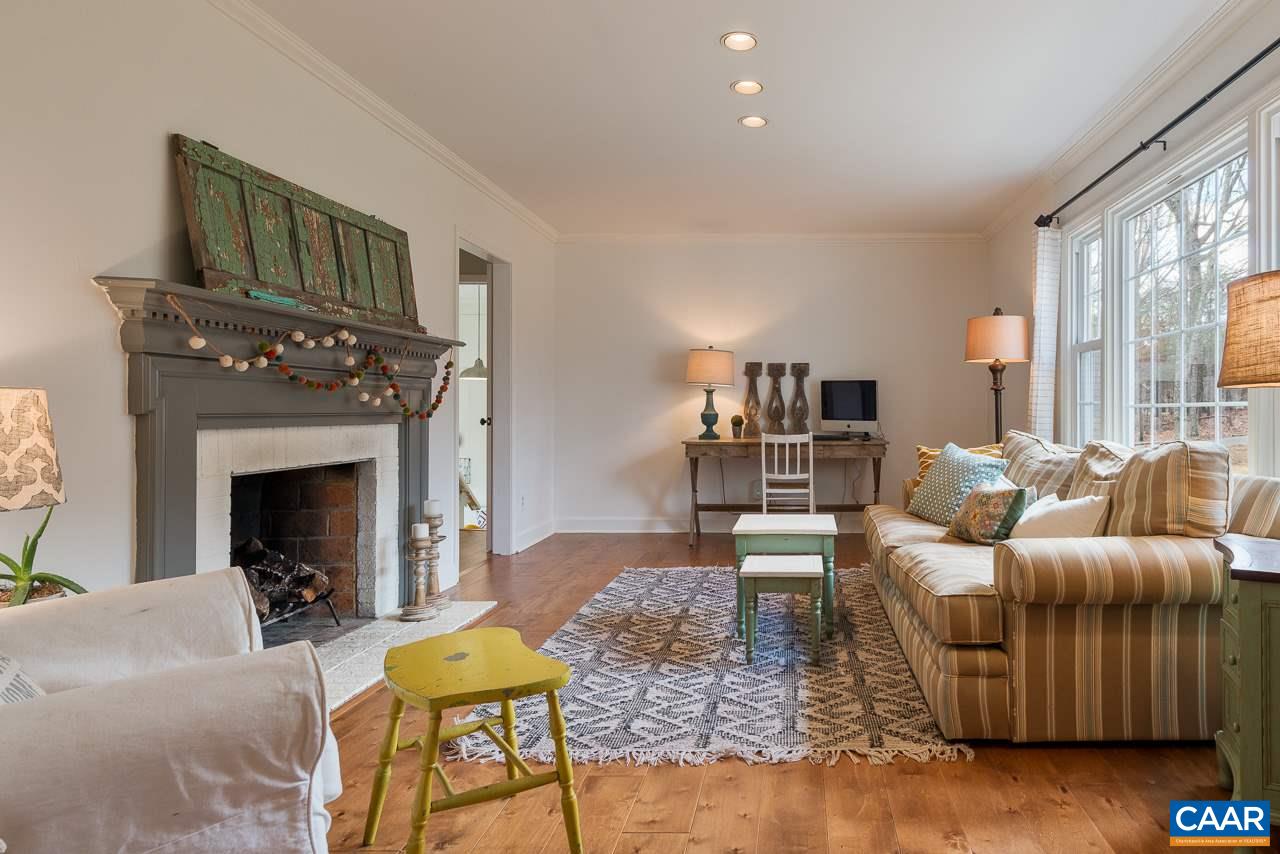 1314 Tilman Road Charlottesville, VA 22901 - Photo 6 of 27 The formal living room is an elegant space with new hardwood flooring and recessed fixtures. A large picture window is flanked by two additional double hung windows making the room bright and affording views of the wooded front yard.