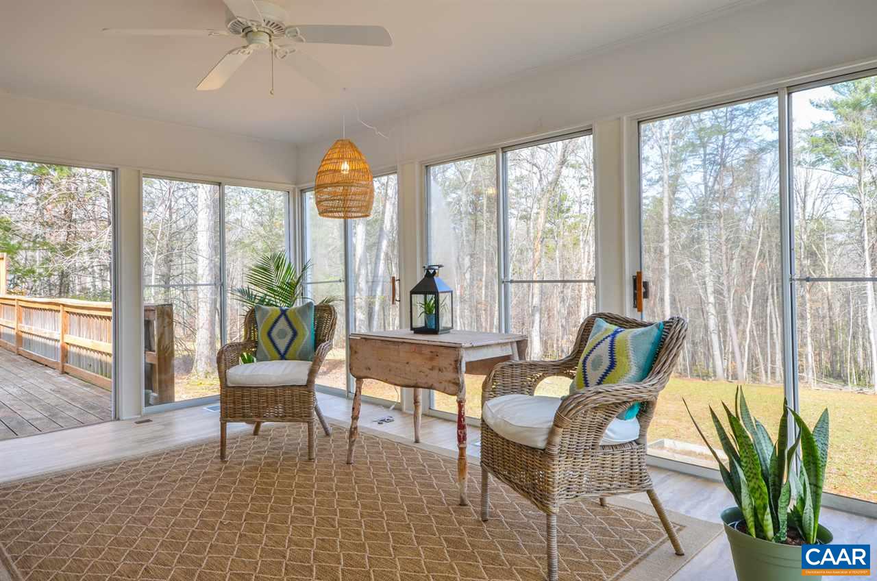 1314 Tilman Road Charlottesville, VA 22901 - Photo 10 of 27 The three season room has three complete walls of sliding glass doors creating a true sense of bringing the outdoors in. To one side is an intimate deck with access to the master and to the other is a patio.