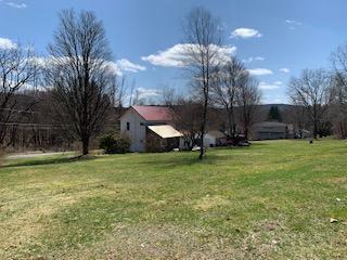 320 Village Road Dallas, PA 18612 - Photo 27 of 29 a view of a house with a yard and basketball court