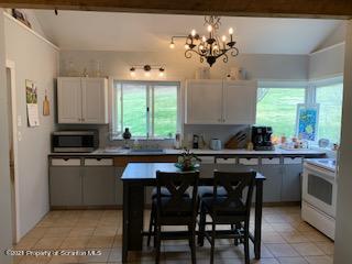 320 Village Road Dallas, PA 18612 - Photo 10 of 29 a kitchen with a table chairs stove and cabinets