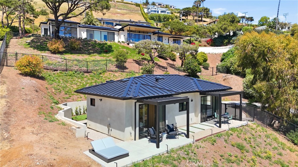 33201 Cuthbert Road Malibu, CA 90265 - Photo 1 of 1 a view of a house with backyard sitting area and garden