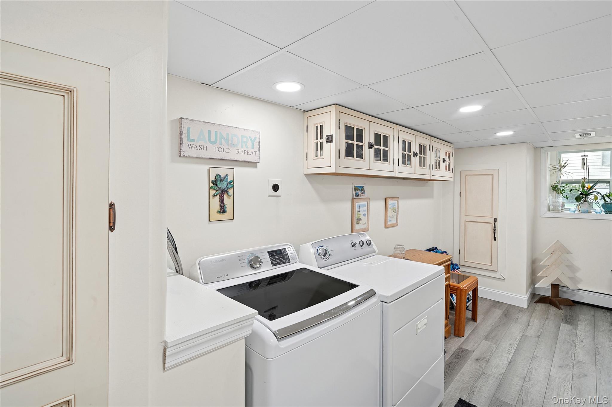 53 Timber Drive Calverton, NY 11933 - Photo 13 of 20 a view of washer and dryer with kitchen countertops