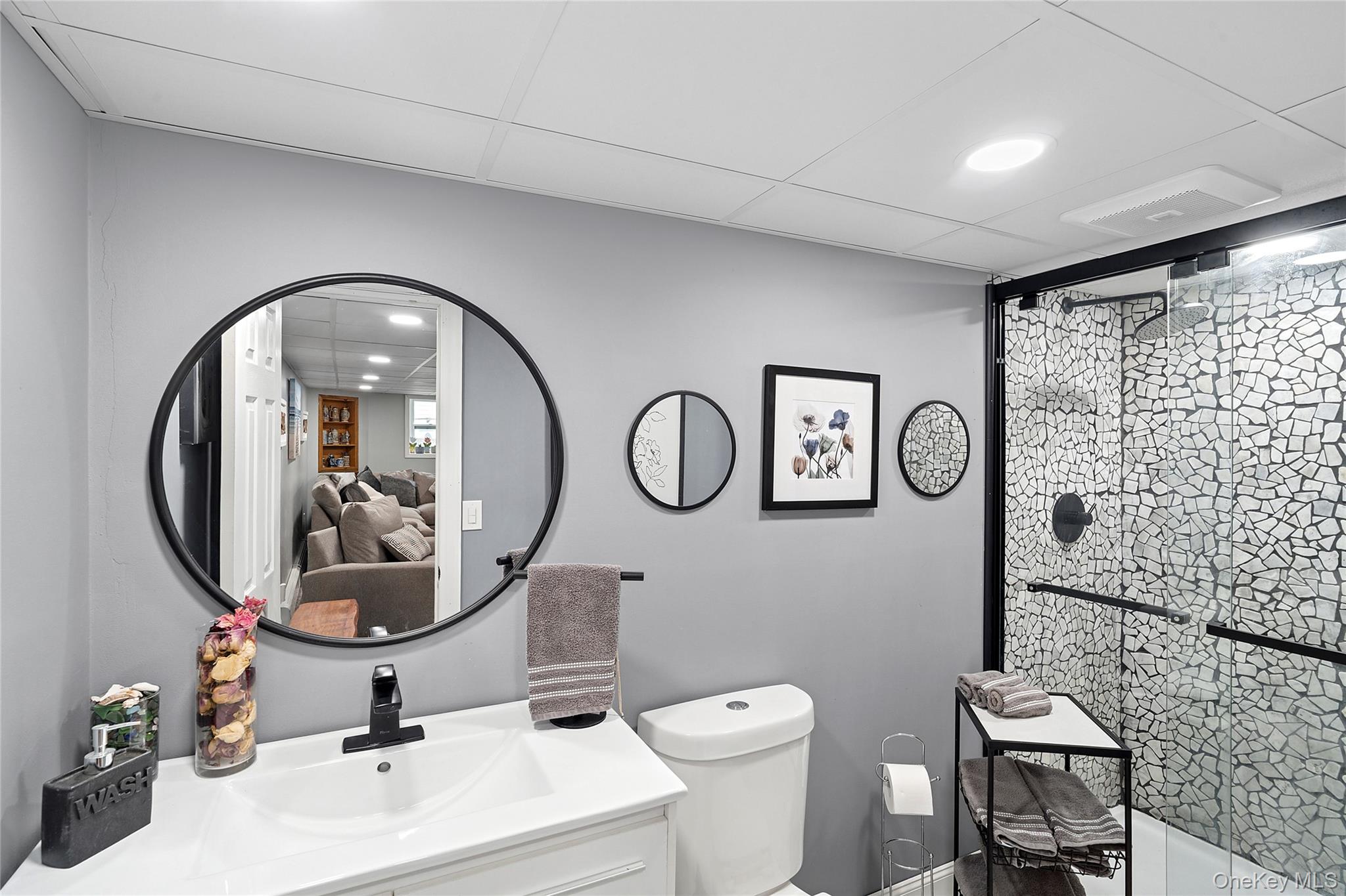 53 Timber Drive Calverton, NY 11933 - Photo 14 of 20 a bathroom with a toilet a sink and a mirror