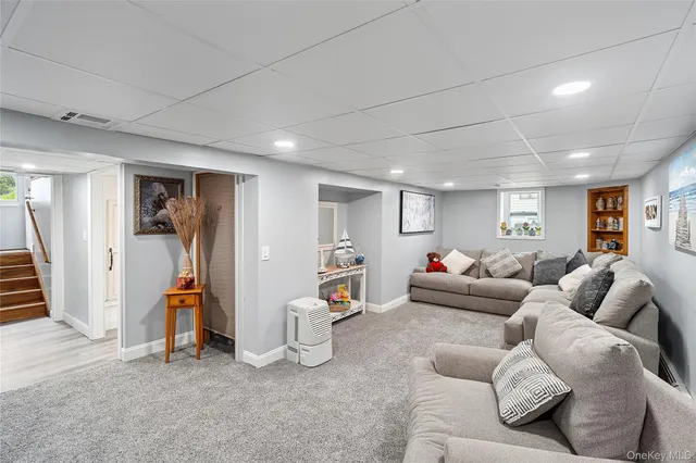a living room with furniture and a gym