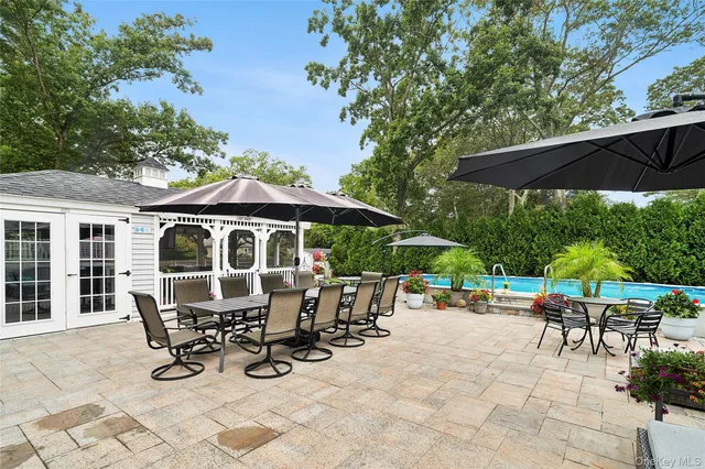 an outdoor space with patio and white umbrellas