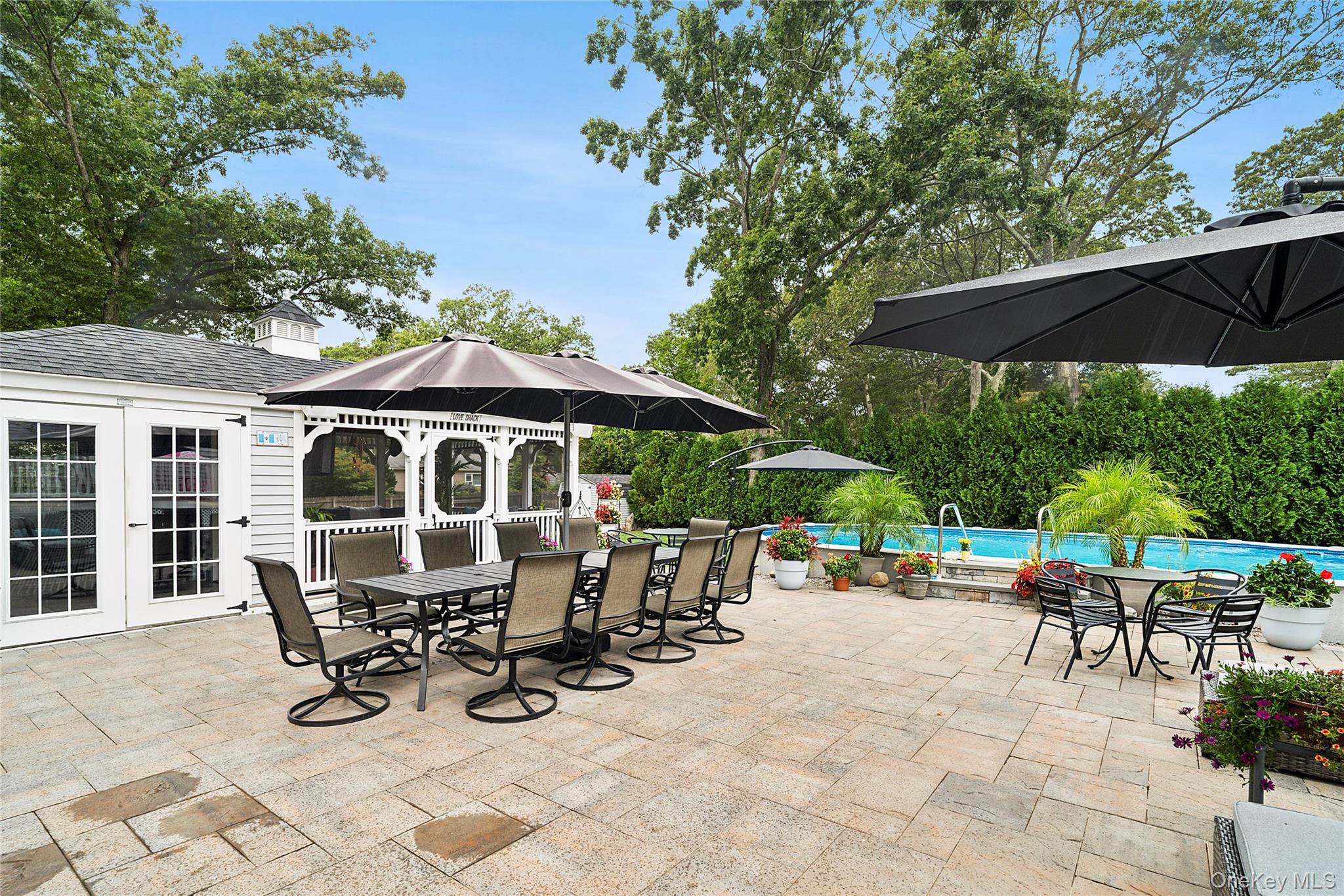53 Timber Drive Calverton, NY 11933 - Photo 19 of 20 an outdoor space with patio and white umbrellas