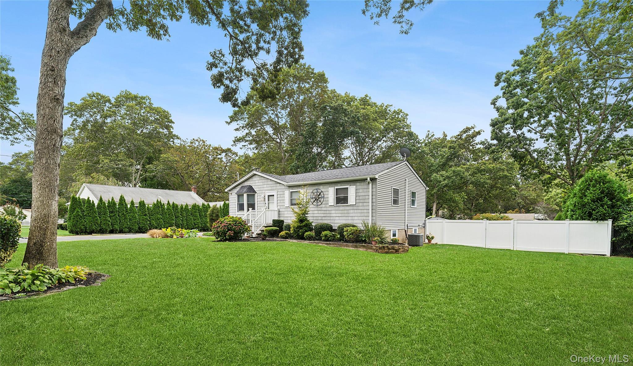 53 Timber Drive Calverton, NY 11933 - Photo 2 of 20 a front view of a house with a garden