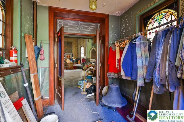 a view of a living room with furniture and clothes