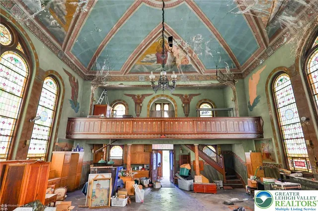 an outdoor living area with furniture and a large window