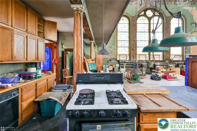 a living room with furniture a fireplace and a floor to ceiling window