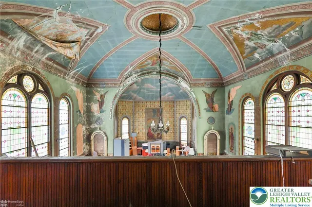 a view of living room filled with furniture and floor to ceiling window