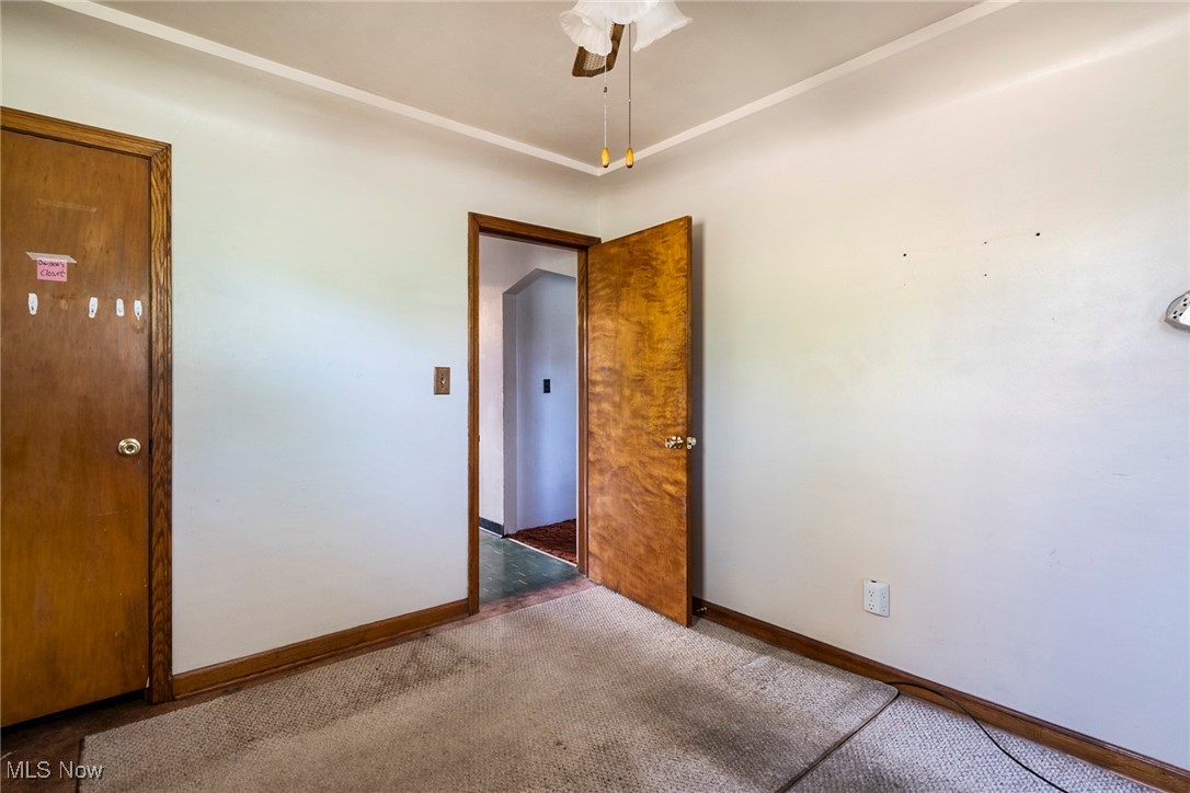 7617 Struthers Road Youngstown, OH 44514 - Photo 17 of 37 Unfurnished room with ceiling fan and dark carpet