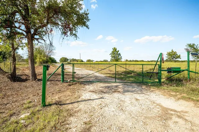 a view of a yard with iron fence