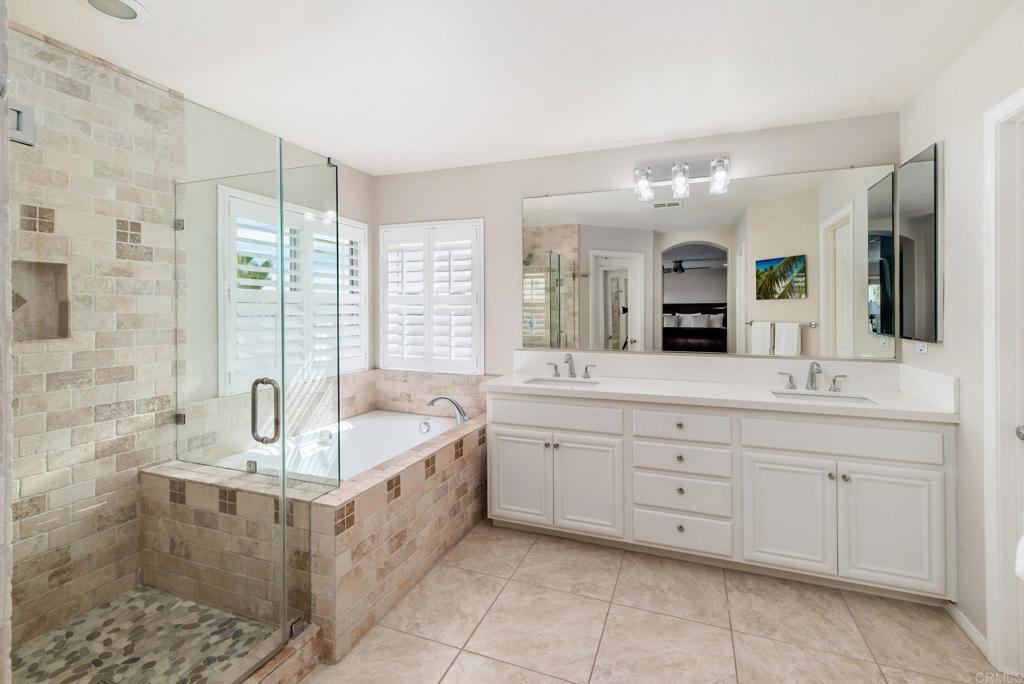 3434 Ravine Drive Carlsbad, CA 92010 - Photo 16 of 37 a spacious bathroom with a granite countertop double vanity sink a mirror and a bathtub