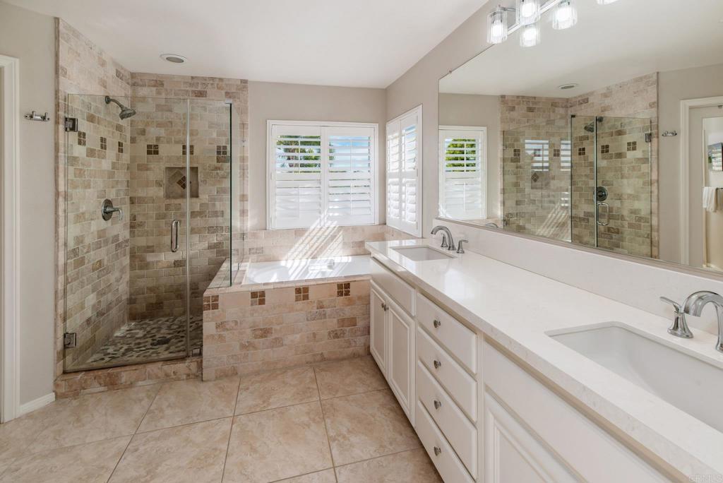 3434 Ravine Drive Carlsbad, CA 92010 - Photo 17 of 37 a spacious bathroom with a double vanity sink a mirror and a shower