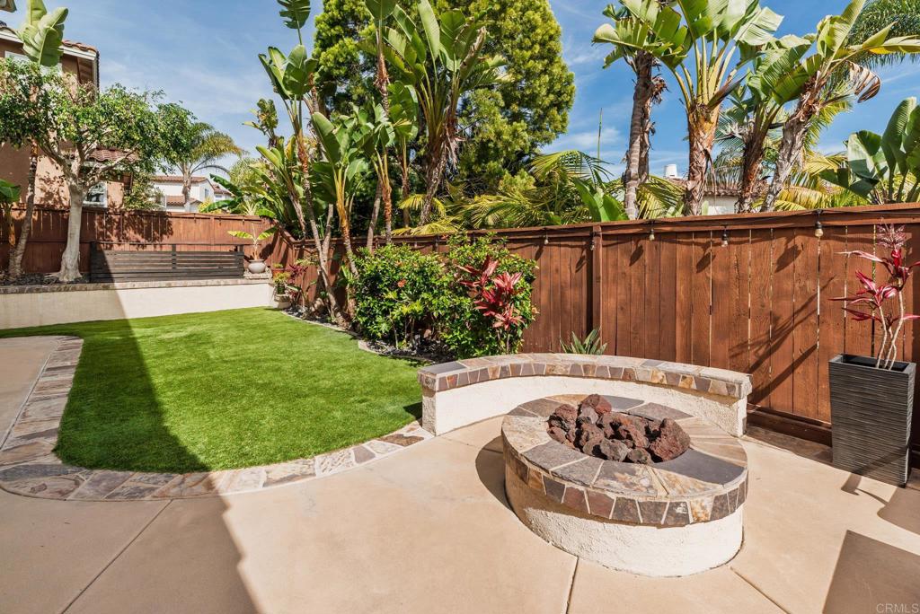 3434 Ravine Drive Carlsbad, CA 92010 - Photo 25 of 37 a wooden floor with a fire pit and trees in the background