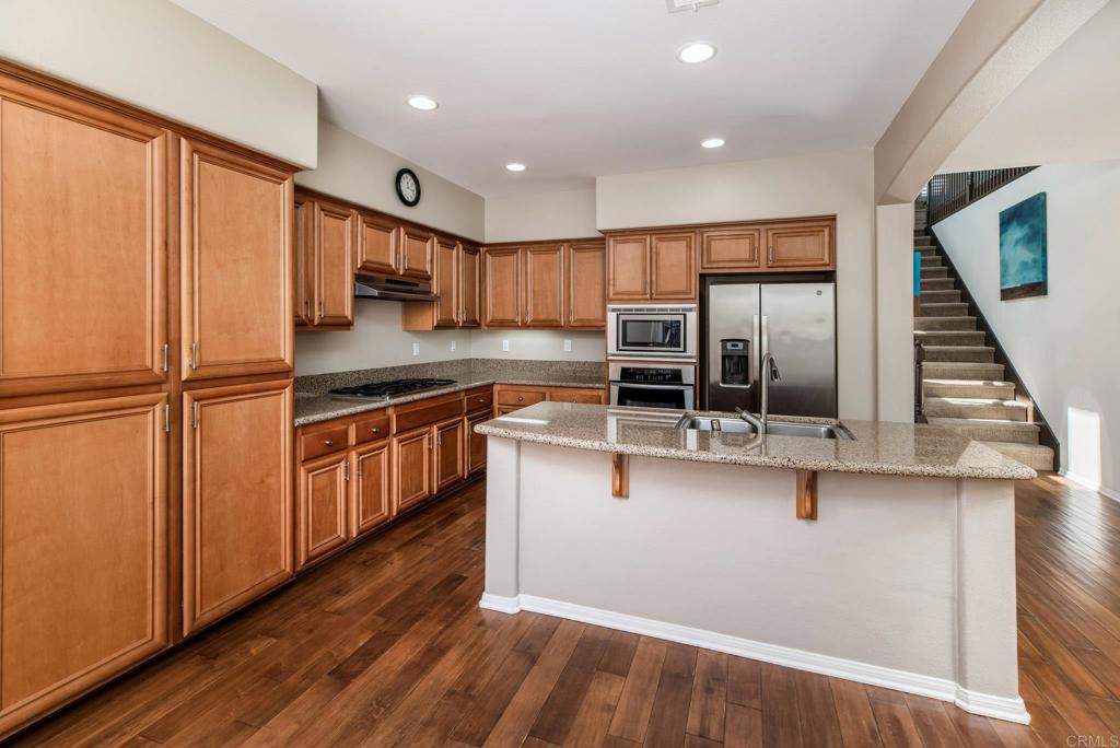 3434 Ravine Drive Carlsbad, CA 92010 - Photo 8 of 37 a kitchen with stainless steel appliances granite countertop a stove a sink and a refrigerator