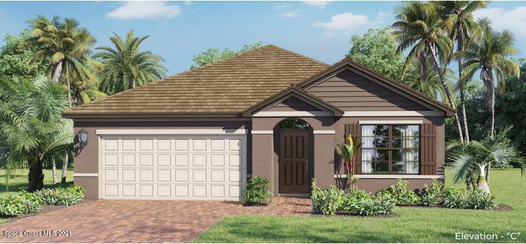 7379 Tourmaline Drive Grant Valkaria, FL 32949 - Photo 1 of 24 a front view of a house with a garden