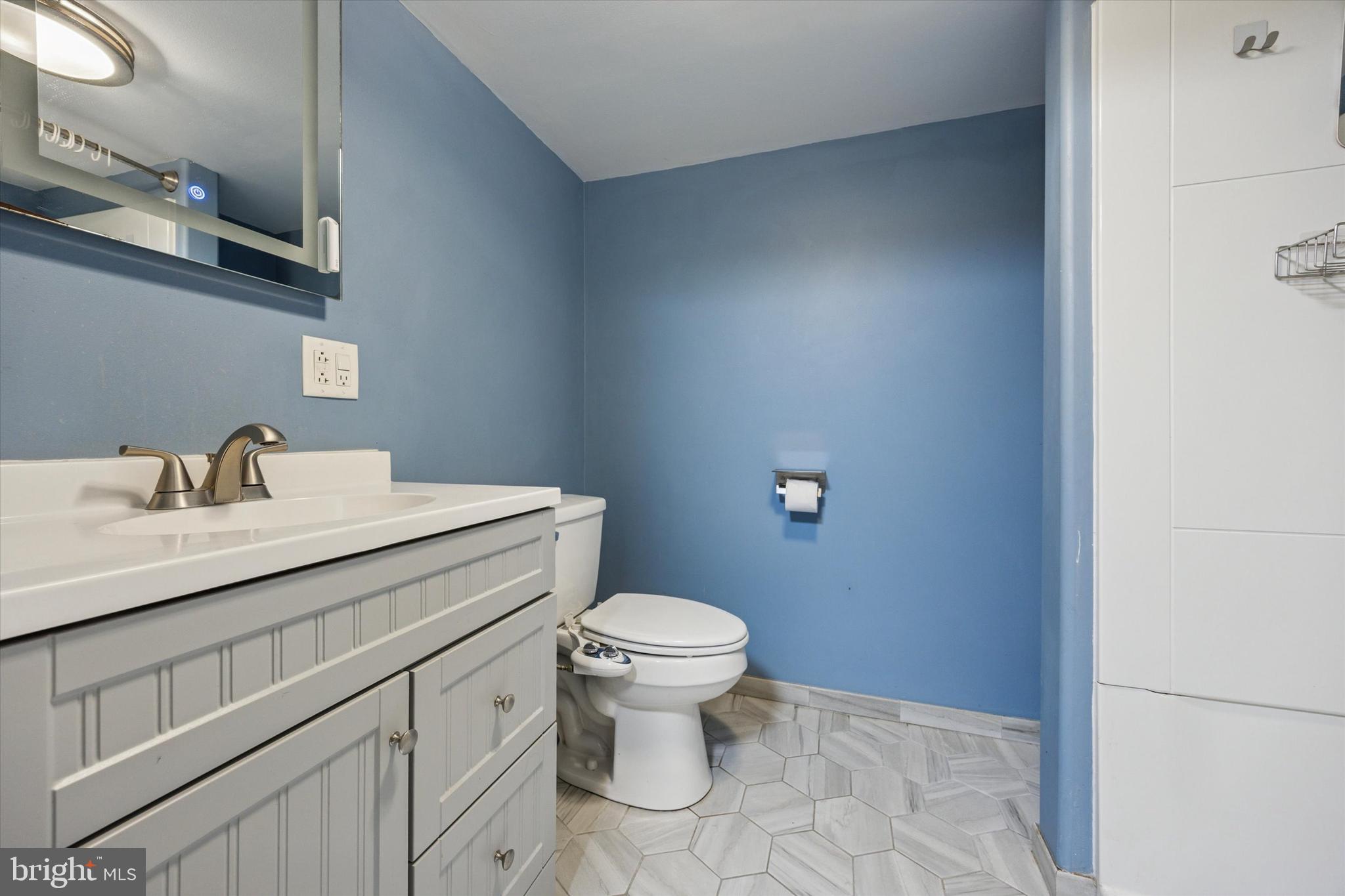 37 Millbrook Road Newark, DE 19713 - Photo 16 of 17 a bathroom with a sink a toilet and a mirror