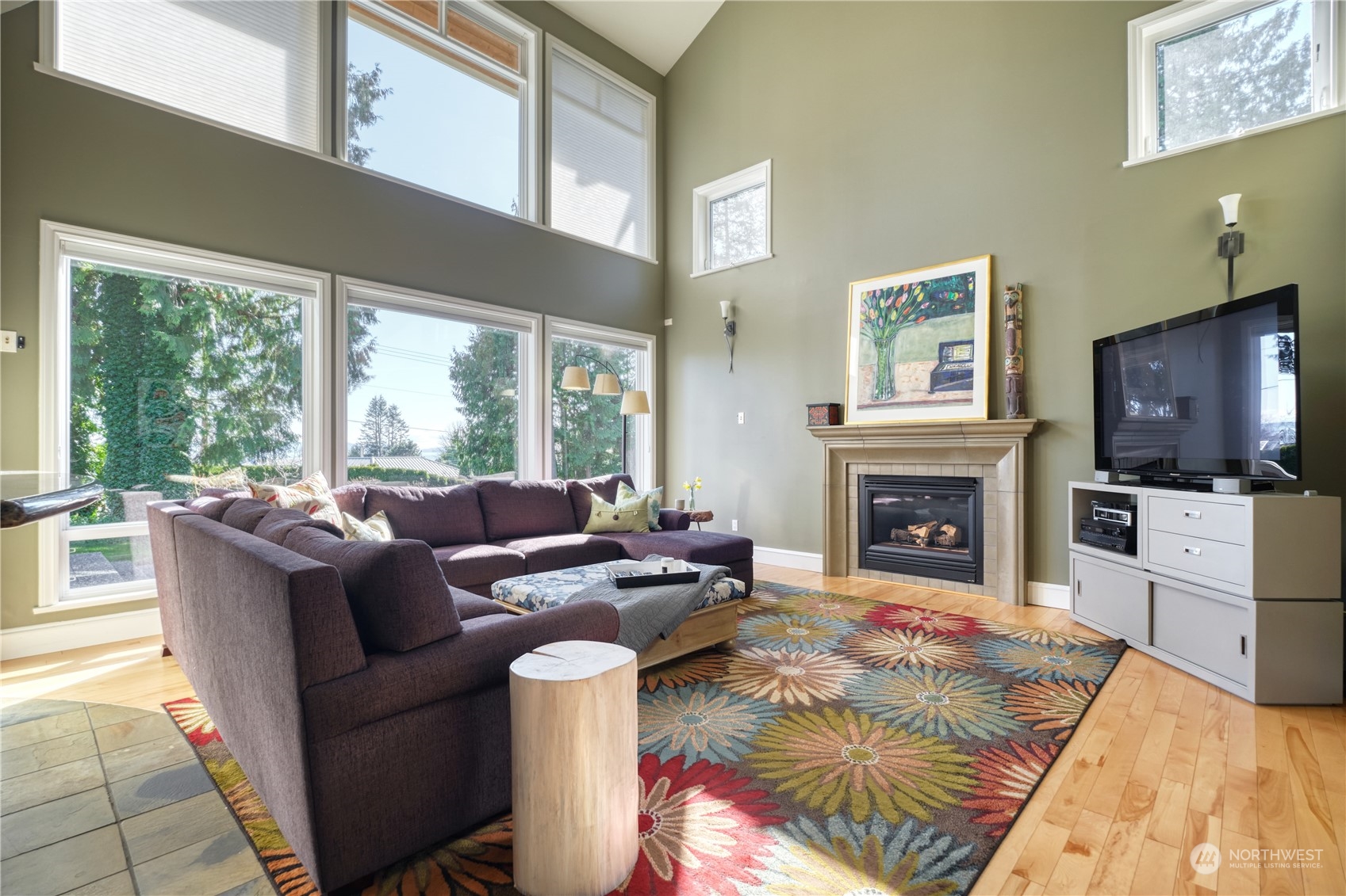 589 South Beach Road Point Roberts, WA 98281 - Photo 11 of 37 a living room with furniture a flat screen tv and a fireplace