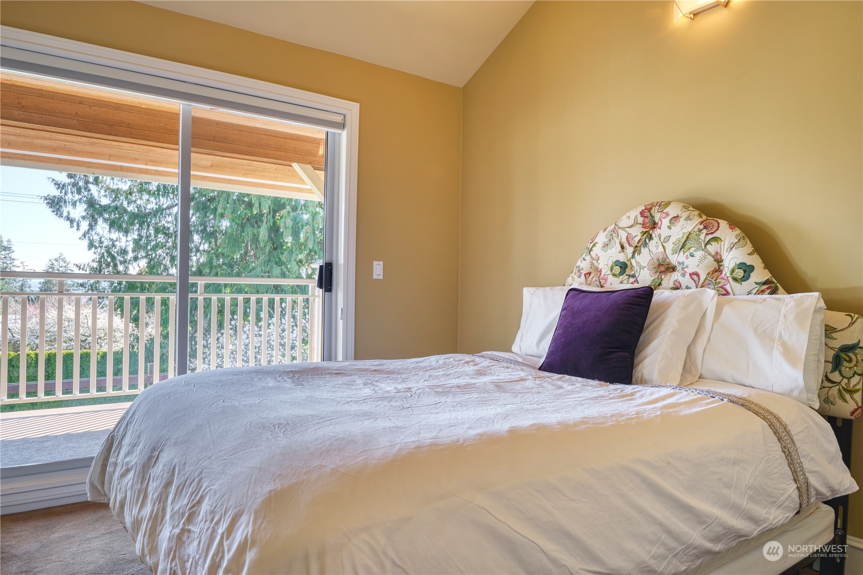 589 South Beach Road Point Roberts, WA 98281 - Photo 23 of 37 a large bed sitting in a bedroom next to a window