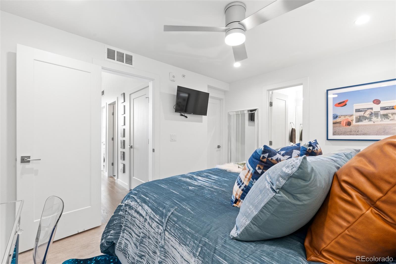 1608 Irving Street Denver, CO 80204 - Photo 23 of 37 a bed room with a bed and a television
