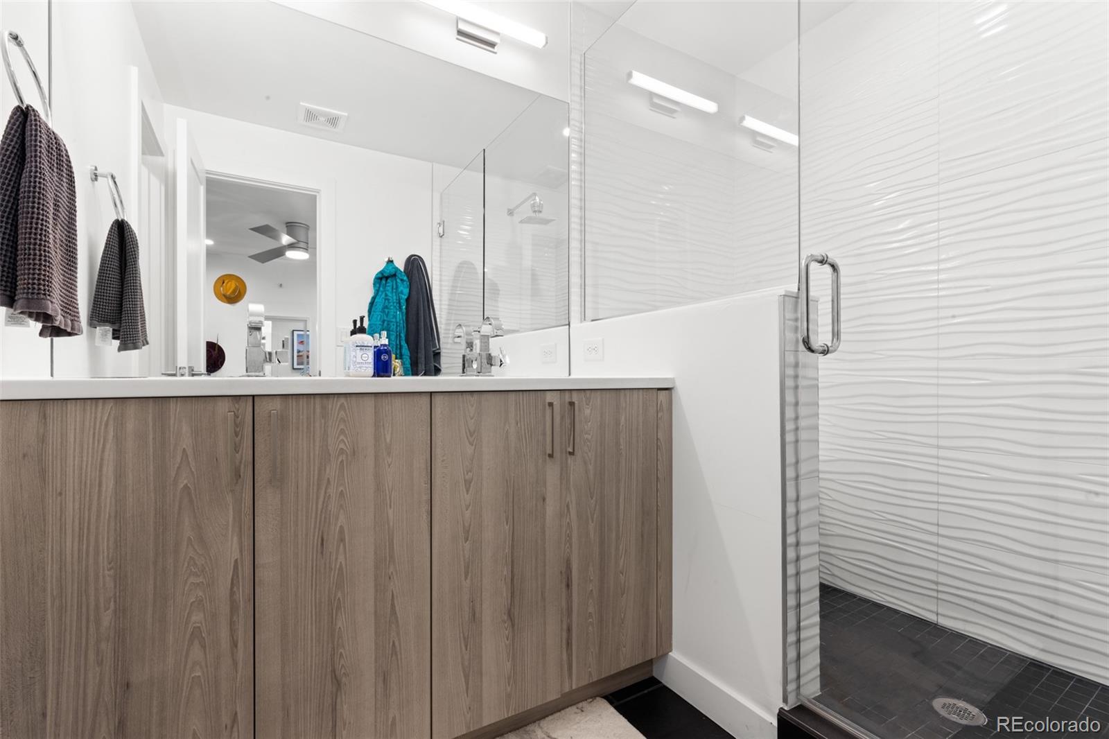 1608 Irving Street Denver, CO 80204 - Photo 24 of 37 a bathroom with a shower and a sink