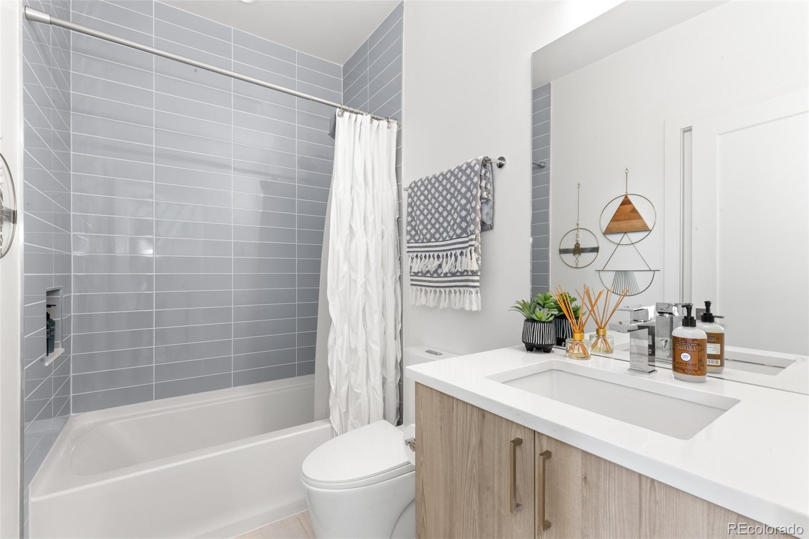 1608 Irving Street Denver, CO 80204 - Photo 25 of 37 a bathroom with a sink toilet and shower